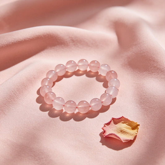 Rose quartz crystal bracelet on a soft pink background, the stone of love